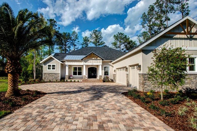 Large transitional beige one-story mixed siding exterior home idea in Orlando