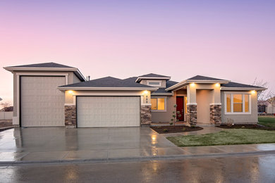 Mid-sized transitional gray one-story stucco exterior home photo in Boise with a hip roof