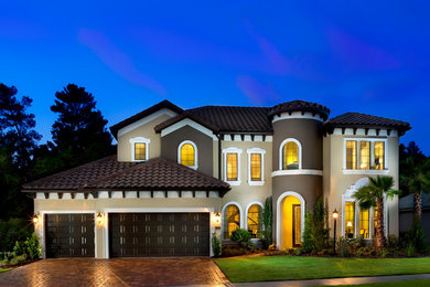 Photo of a large mediterranean two floor render house exterior in Orlando.