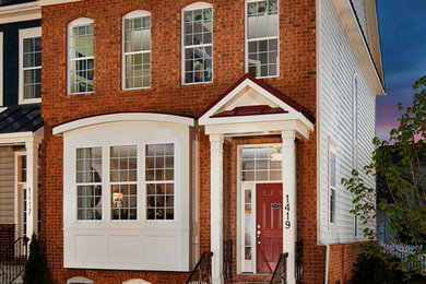 Example of a brown two-story brick exterior home design in DC Metro