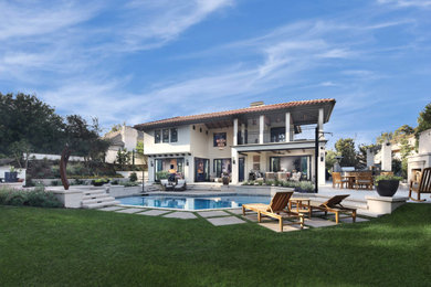Transitional white two-story house exterior photo in Orange County with a hip roof and a tile roof