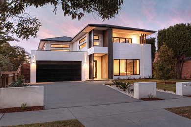 Example of a large trendy white two-story house exterior design in Melbourne with a tile roof