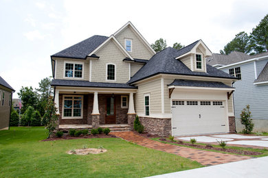 Example of a mid-sized transitional two-story vinyl exterior home design in Raleigh
