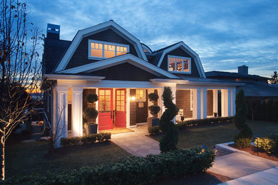 Example of a mid-sized ornate two-story wood exterior home design in Seattle with a gambrel roof