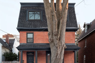 Inspiration for a mid-sized transitional red three-story brick house exterior remodel in Ottawa with a shingle roof