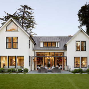 Inspiration for a cottage white two-story exterior home remodel in San Francisco with a metal roof