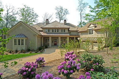 Inspiration for a large timeless beige two-story wood exterior home remodel in Huntington with a shingle roof