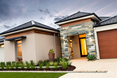 Photo of a beige contemporary bungalow house exterior in Perth.