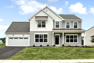Example of a large classic gray two-story vinyl exterior home design in Other with a shingle roof
