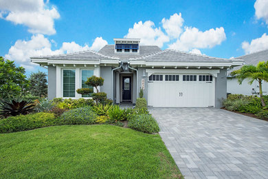 Mid-sized transitional gray one-story stucco exterior home photo in Other with a shingle roof