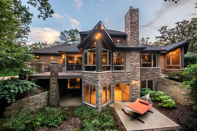Example of a large trendy gray two-story stone exterior home design in Other with a shingle roof
