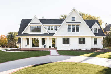 Large elegant white two-story wood exterior home photo in Minneapolis with a shingle roof