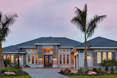Huge transitional gray one-story mixed siding house exterior idea in Tampa with a hip roof and a tile roof