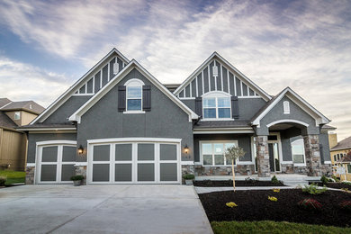 Inspiration for a mid-sized timeless gray two-story stucco house exterior remodel in Kansas City