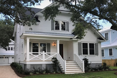 Example of a mid-sized classic white two-story concrete fiberboard exterior home design in Charleston with a shingle roof