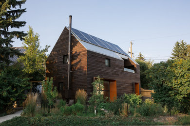 Inspiration for a small scandinavian brown two-story wood exterior home remodel in Calgary with a metal roof