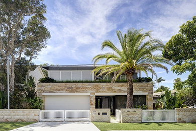 Стильный дизайн: большой, двухэтажный, бежевый дом в морском стиле с облицовкой из камня - последний тренд