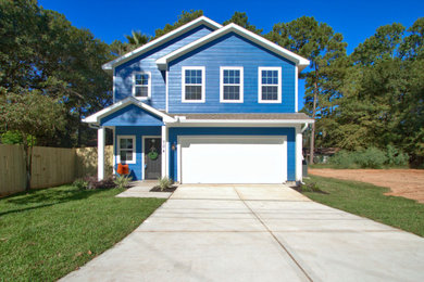 Mid-sized blue two-story concrete fiberboard exterior home idea in Houston with a shingle roof