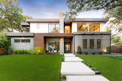 Inspiration for a mid-sized contemporary multicolored two-story mixed siding exterior home remodel in Dallas