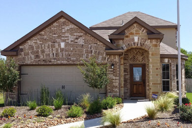 Example of a mid-sized transitional multicolored two-story mixed siding exterior home design in Austin with a hip roof