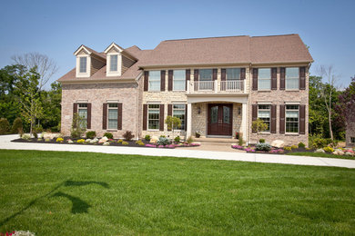 Inspiration for a large transitional two-story brick exterior home remodel in Cincinnati