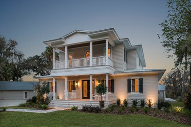 Large farmhouse gray two-story mixed siding exterior home idea in Orlando with a hip roof