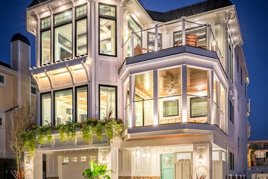 Inspiration for a coastal white three-story exterior home remodel in Other
