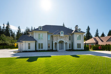 Example of a large classic gray three-story mixed siding house exterior design in Vancouver with a clipped gable roof and a shingle roof