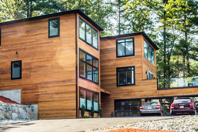 Example of a trendy brown three-story wood exterior home design in Boston