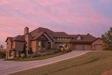 Inspiration for a large timeless brown two-story stone exterior home remodel in Other with a shingle roof