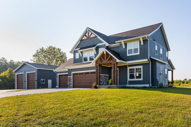 Mid-sized cottage blue two-story vinyl exterior home photo in Grand Rapids with a shingle roof