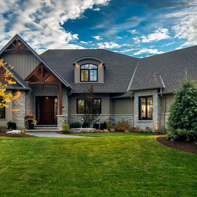 Example of a large arts and crafts gray two-story mixed siding exterior home design in Toronto with a hip roof