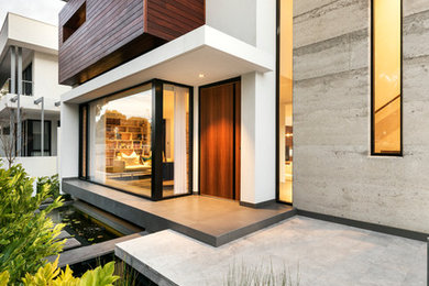 White contemporary house exterior in Perth with three floors and a flat roof.