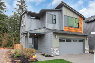 Mid-sized transitional gray two-story concrete fiberboard exterior home idea in Portland with a shed roof