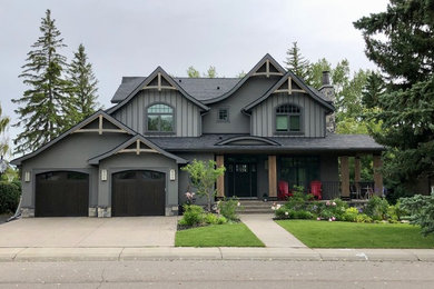 Elegant gray stucco gable roof photo in Calgary with a shingle roof