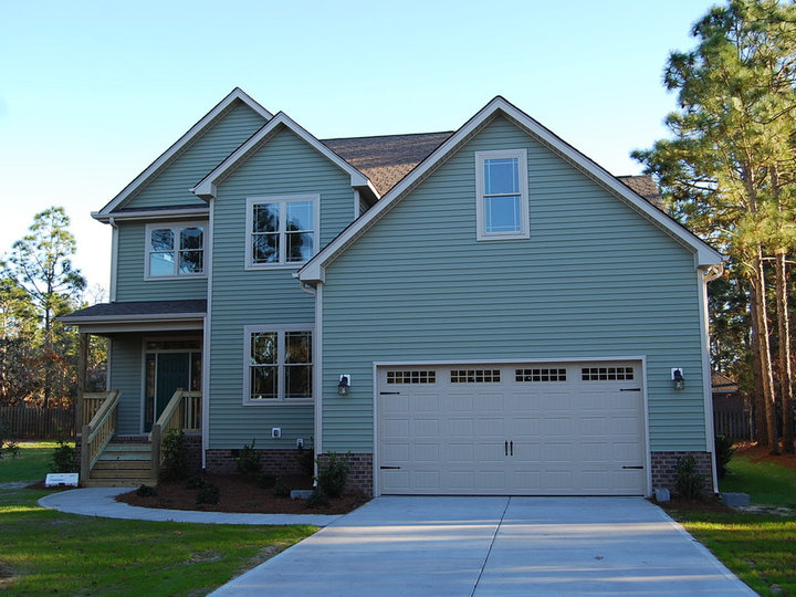 Traditional green two-story vinyl exterior home idea