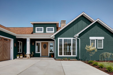 Green classic bungalow detached house in Salt Lake City with mixed cladding, a pitched roof and a shingle roof.