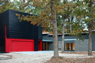 Mid-sized modern black two-story metal house exterior idea in Charlotte with a shed roof and a metal roof