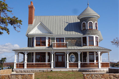 Diseño de fachada de casa gris clásica extra grande de tres plantas con revestimiento de madera, tejado a dos aguas y tejado de metal