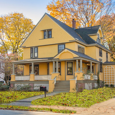 Ornate yellow exterior home photo in Boston