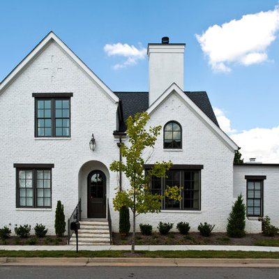 Inspiration for a timeless white two-story brick exterior home remodel in Nashville