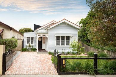 White traditional bungalow detached house in Melbourne with a pitched roof.