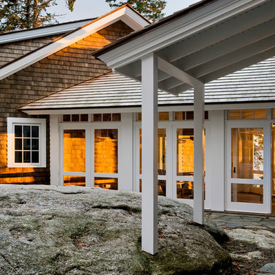 Example of a beach style wood exterior home design in Portland Maine