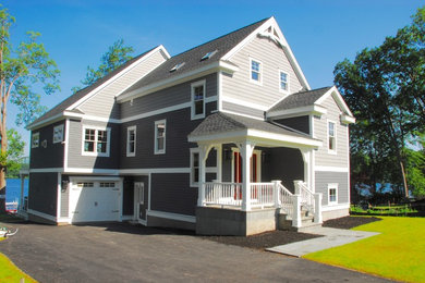 Пример оригинального дизайна: большой, трехэтажный, серый дом в стиле неоклассика (современная классика) с облицовкой из ЦСП и двускатной крышей