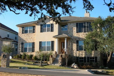 Elegant three-story brick exterior home photo in Austin
