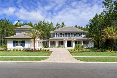 Example of a large beach style multicolored two-story mixed siding house exterior design in Jacksonville