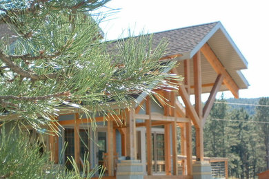 Esempio della villa blu rustica a due piani di medie dimensioni con rivestimento in legno, tetto a capanna e copertura a scandole