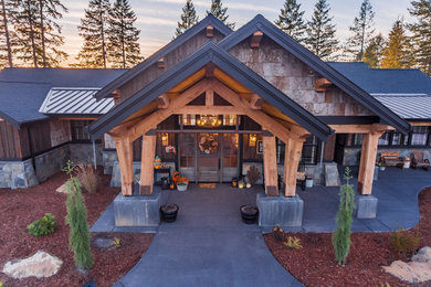 Inspiration for a large rustic brown one-story wood exterior home remodel in Portland with a mixed material roof