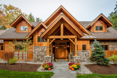 Inspiration for a rustic two-story wood gable roof remodel in Manchester