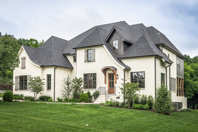 Traditional white two-story brick exterior home idea in Nashville